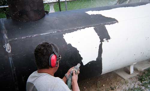 LP gas tank paint removal in progress