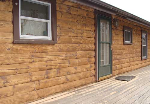 Front of log home after soda cleaning