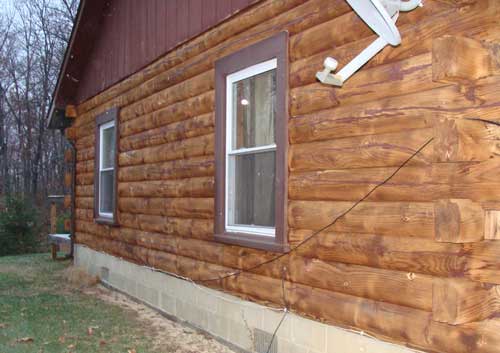 Log home cleaning & restoration.  Log cabin side after paint removed