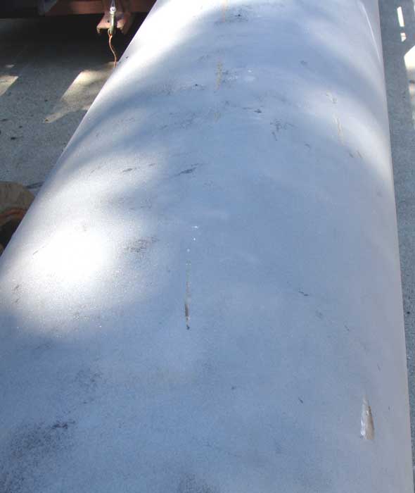 Oilfield pipe with fabric wrapping removed by soda blasting