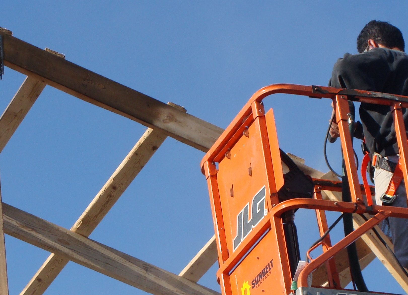 Soda Clean technician removes smoke residue from barn rafters after a fire.