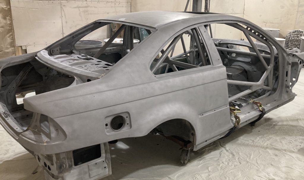 Media blasting & powder coating.  This is BMW Racer after media blasting removed all interior and exterior paint.