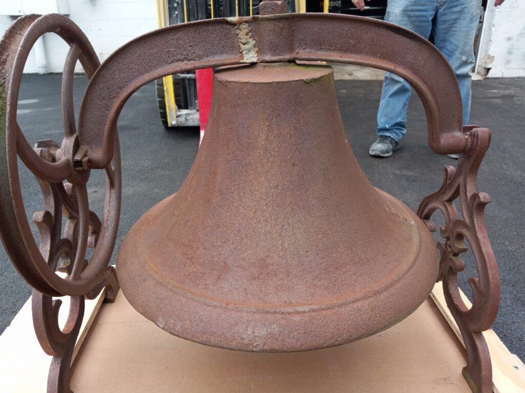 Paint and metal stripping. Vintage school bell before restoration with soda blasting and powder coating.